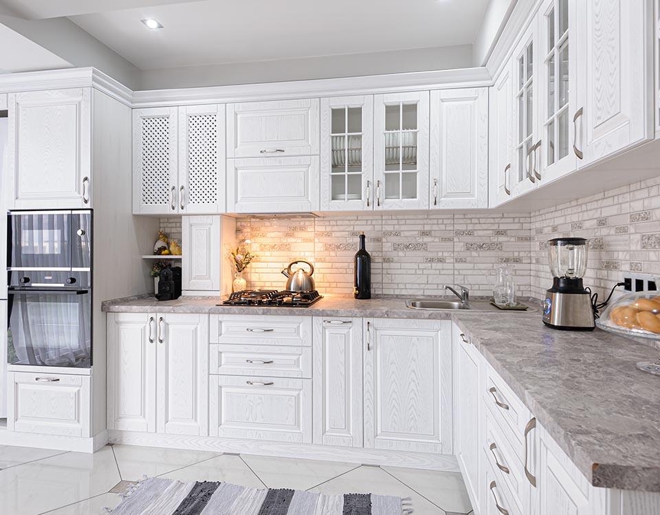 Kitchen with country style cabinets and benchtops